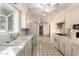 View of the kitchen with gas stove and white cabinets at 7622 N 7Th Ave, Phoenix, AZ 85021