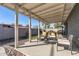 A covered back patio with outdoor seating and lush desert landscaping at 7743 E Roosevelt St, Scottsdale, AZ 85257