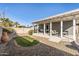 Backyard view featuring a covered patio, desert landscaping and artificial green grass at 7743 E Roosevelt St, Scottsdale, AZ 85257