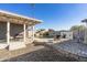 A spacious backyard featuring a covered patio, pool, desert landscaping, and ample seating area at 7743 E Roosevelt St, Scottsdale, AZ 85257