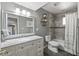 Neutral bathroom with a large vanity, decorative mirror, and a shower-tub combo at 7743 E Roosevelt St, Scottsdale, AZ 85257