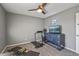 Bedroom featuring a treadmill, carpeted floor, and a ceiling fan at 7743 E Roosevelt St, Scottsdale, AZ 85257