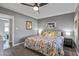 Well-lit bedroom featuring plush carpeting, ceiling fan, and a brightly colored floral bedspread at 7743 E Roosevelt St, Scottsdale, AZ 85257