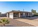 Attractive single-story home with an extended driveway, neutral tones, and a convenient carport at 7743 E Roosevelt St, Scottsdale, AZ 85257