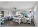 Open-concept living room with hardwood floors, neutral decor, and a combined dining area at 7743 E Roosevelt St, Scottsdale, AZ 85257