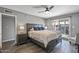 This main bedroom features wood floors, ceiling fan and sliding glass doors to the backyard at 7743 E Roosevelt St, Scottsdale, AZ 85257