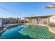 An inviting pool area with desert landscaping, and covered patio at 7743 E Roosevelt St, Scottsdale, AZ 85257