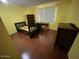 Bedroom with hardwood floor, bookcase, and desk at 7828 N 47Th Ave, Glendale, AZ 85301