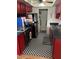 Kitchen with red cabinets, checkerboard floor, and appliances at 7828 N 47Th Ave, Glendale, AZ 85301