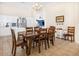 Dining room with a wood table and chairs, adjacent to the kitchen at 7908 W Rose Garden Ln, Peoria, AZ 85382