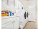 Spacious laundry room with washer, dryer, and cabinets at 7908 W Rose Garden Ln, Peoria, AZ 85382