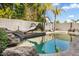 Refreshing pool with rock landscaping and palm trees at 7908 W Rose Garden Ln, Peoria, AZ 85382