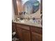 Clean bathroom with wood vanity and a large vanity mirror at 8210 E Garfield St # K213, Scottsdale, AZ 85257