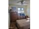 Small bedroom with double bed, dresser, and window at 8210 E Garfield St # K213, Scottsdale, AZ 85257