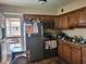 Kitchen with wood cabinets, access to patio at 8210 E Garfield St # K213, Scottsdale, AZ 85257