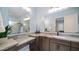 Modern bathroom with single sink, granite countertop, and a large mirror at 8519 E Regina Cir, Mesa, AZ 85207