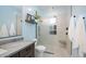 Clean bathroom with walk-in shower, granite countertop, and modern fixtures at 8519 E Regina Cir, Mesa, AZ 85207