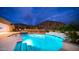 Stunning pool and spa at night with mountain backdrop at 8519 E Regina Cir, Mesa, AZ 85207