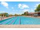 Community pool with lounge chairs and surrounding patio at 8519 E Regina Cir, Mesa, AZ 85207