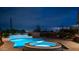 Luxury pool and spa at night with city views at 8519 E Regina Cir, Mesa, AZ 85207