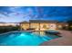 Backyard oasis featuring a stunning pool and spa at night at 8519 E Regina Cir, Mesa, AZ 85207