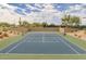 Well-maintained tennis court with surrounding landscaping at 8519 E Regina Cir, Mesa, AZ 85207