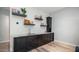 Modern wet bar with dark cabinetry and granite countertop at 8519 E Regina Cir, Mesa, AZ 85207