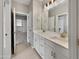 Double vanity bathroom with white cabinets and gold fixtures at 10211 E Wavelength Ave, Mesa, AZ 85212