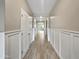 Bright hallway with wood-look tile flooring and wainscoting at 10211 E Wavelength Ave, Mesa, AZ 85212