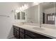 Bathroom boasts a double vanity, large mirror, and dark wood cabinets at 10960 E Monte Ave # 223, Mesa, AZ 85209