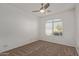 Well-lit bedroom with ceiling fan and arched window with shutters at 10960 E Monte Ave # 223, Mesa, AZ 85209