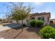 House exterior with two-car garage and desert landscaping at 10960 E Monte Ave # 223, Mesa, AZ 85209