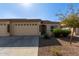 House exterior with two-car garage and desert landscaping at 10960 E Monte Ave # 223, Mesa, AZ 85209