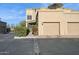 Tan two-story home with two-car garage and landscaped walkway at 11022 N Indigo Dr # 121, Fountain Hills, AZ 85268