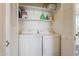 White washer and dryer set in a laundry closet with shelving at 11022 N Indigo Dr # 121, Fountain Hills, AZ 85268