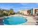 Community pool with lounge chairs and umbrellas at 11022 N Indigo Dr # 121, Fountain Hills, AZ 85268