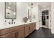 Bathroom with double vanity, large mirror, and walk-in closet at 12059 N Luckenbach St, Surprise, AZ 85388