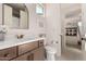 Modern bathroom with vanity, toilet and access to bedroom at 12059 N Luckenbach St, Surprise, AZ 85388