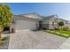 Modern home with a white garage door and landscaped front yard at 12059 N Luckenbach St, Surprise, AZ 85388