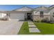 Craftsman style home with stone accents and a two-car garage at 12059 N Luckenbach St, Surprise, AZ 85388