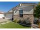 Modern home exterior with stone accents and a two car garage at 12059 N Luckenbach St, Surprise, AZ 85388