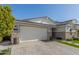 Two-story home with stone and stucco exterior, and a large garage at 12059 N Luckenbach St, Surprise, AZ 85388