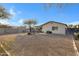 Spacious backyard with gravel and a fire pit at 1272 E Dust Devil Dr, San Tan Valley, AZ 85143