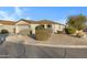 Single-story home with attached garage and well-manicured landscaping at 1272 E Dust Devil Dr, San Tan Valley, AZ 85143