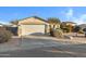 Single-story home with attached garage and desert landscaping at 1272 E Dust Devil Dr, San Tan Valley, AZ 85143