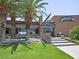 Inviting clubhouse entrance with stone accents and palm trees at 12952 W Eagle Ridge Ln, Peoria, AZ 85383