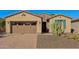 House exterior with desert landscaping and a two-car garage at 12952 W Eagle Ridge Ln, Peoria, AZ 85383