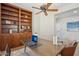 Home office with built-in shelving and ceiling fan at 12952 W Eagle Ridge Ln, Peoria, AZ 85383