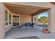 Covered patio with seating area and brick flooring at 12952 W Eagle Ridge Ln, Peoria, AZ 85383