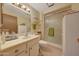 Bathroom with a single sink, shower, and linen storage at 13226 W Mesa Verde Dr, Sun City West, AZ 85375